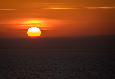 Scenic view of sea against romantic sky at sunset