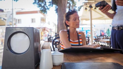 Woman sitting on table at cafe