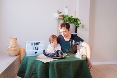 Women sitting on table at home