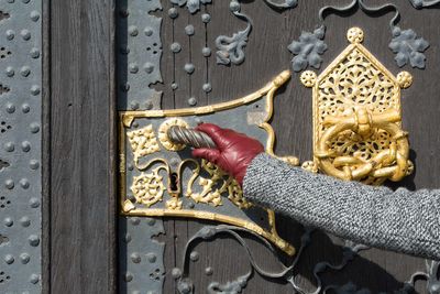 Cropped image of woman holding door handle