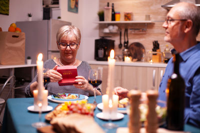 Portrait of senior man preparing food at table