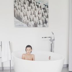 Portrait of woman sitting in bathroom