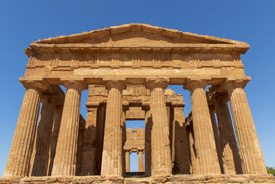 Low angle view of old ruins of temple against clear sky