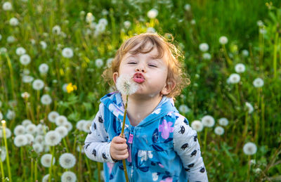 Portrait of cute girl blowing bubbles