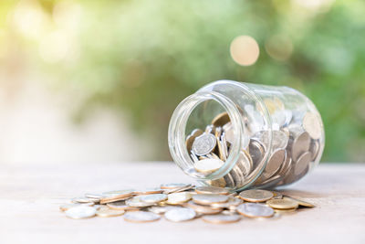 Saving money coins in jug glass. concept finance and saving.