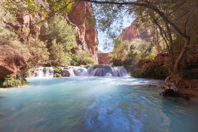 Scenic view of river flowing through rocks