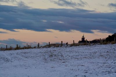 Scenic view of beach against sky during winter