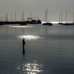 Silhouette of man standing in sea