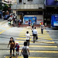 People walking on sidewalk in city