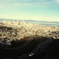 High angle view of road by buildings against sky