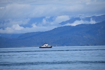 Boat sailing in sea against sky