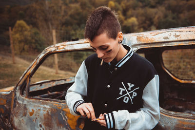 Full length of young man sitting in car