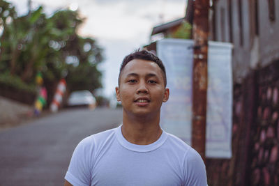 Portrait of young man standing outdoors