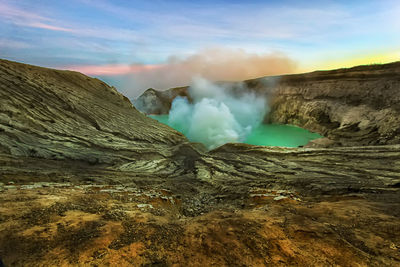 Smoke emitting from volcanic mountain against sky