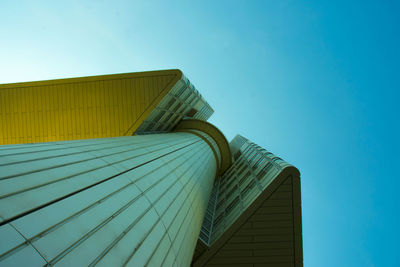 Low angle view of skyscraper against clear blue sky