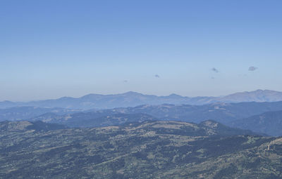 Scenic view of mountains against clear blue sky