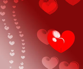 Close-up of red heart shape over colored background