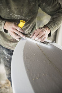 Surfboard shaper refining a new design