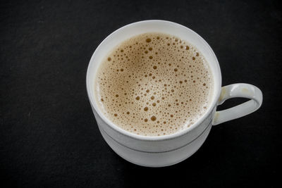 Close-up of coffee cup against black background