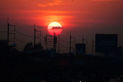 Silhouette buildings against sky during sunset