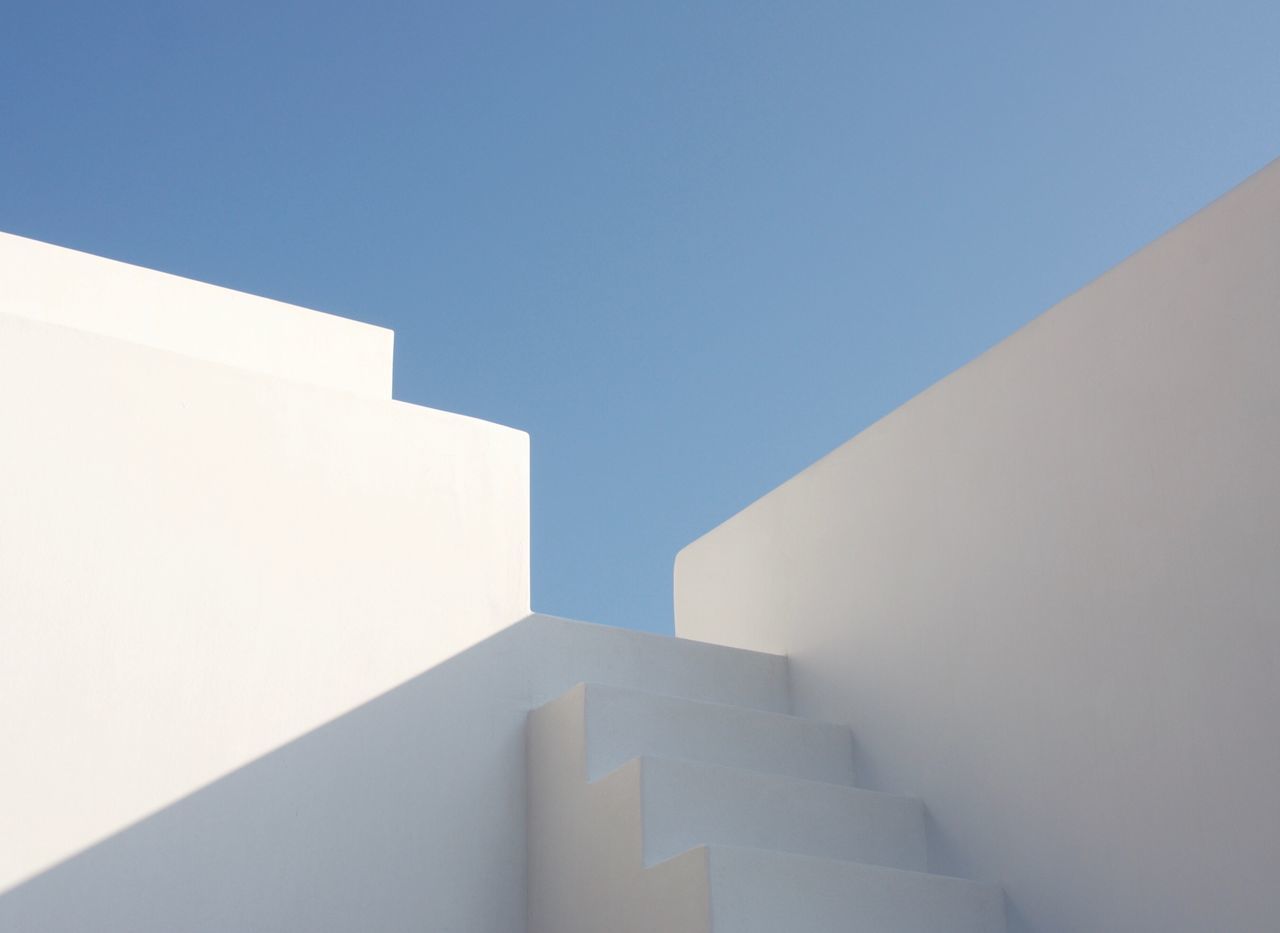 low angle view, steps and staircases, clear sky, architecture, white color, copy space, staircase, built structure, day, no people, whitewashed, outdoors, building exterior, close-up, sky