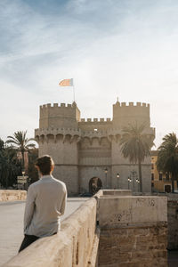 Valencia's torres de serrano at sunset with a young man