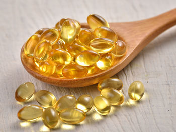 Cod liver oil capsules on table