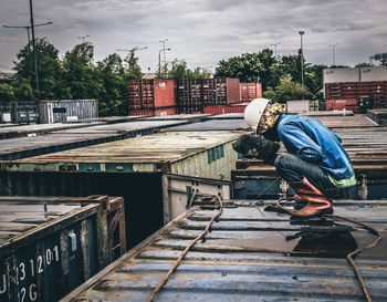 Side view of man standing against the sky