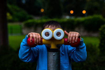 Close-up of boy playing on ride at playground