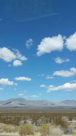 Scenic view of mountains against cloudy sky