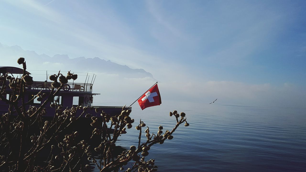 flag, patriotism, low angle view, no people, sky, nature, outdoors, beauty in nature, day, water