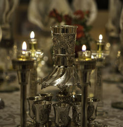 Close-up of illuminated candles on table