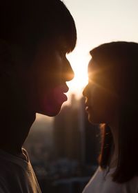 Close-up of couple kissing at sunset