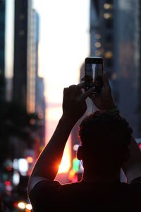 Portrait of man photographing through smart phone