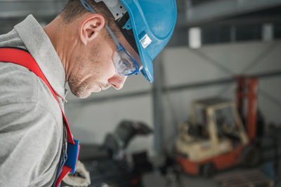 Close-up of mechanic working in factory