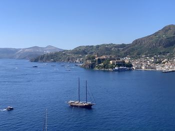 Sailboats in sea against clear sky