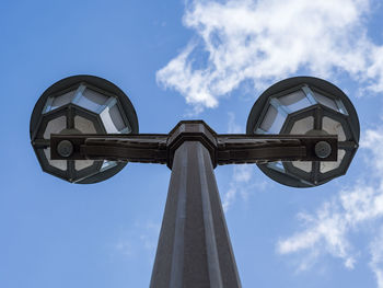 Low angle view of street lamp at karl marx allee against blue sky