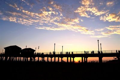 Pier on sea at sunset