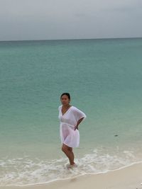 Full length of woman standing at beach