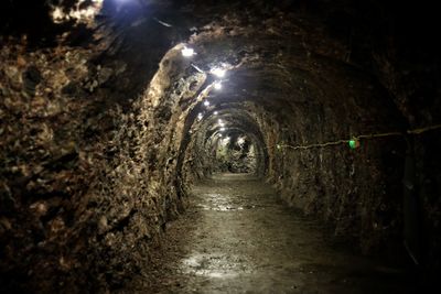 Walkway in illuminated tunnel