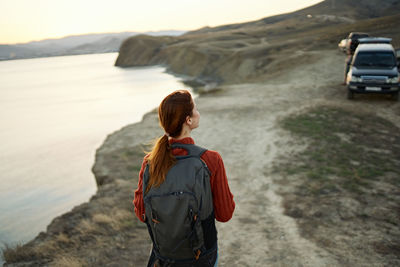 Young woman looking at sea shore