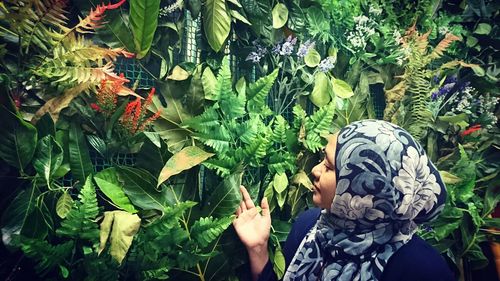 Midsection of woman standing on plants