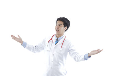 Full length of smiling young man against white background