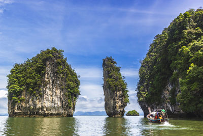 Scenic view of rocks in sea against sky