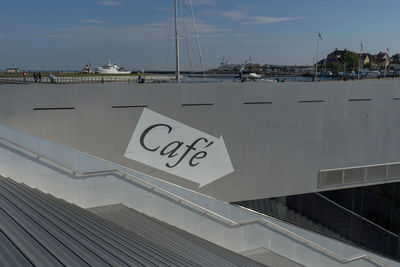 Information sign on railing against sky