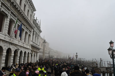 Crowd at town square against clear sky