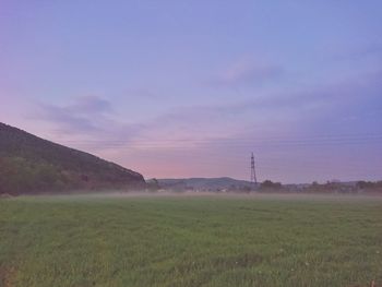 Scenic view of field against sky during sunset