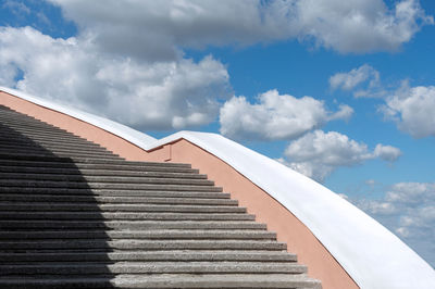 Low angle view of staircase by building against sky