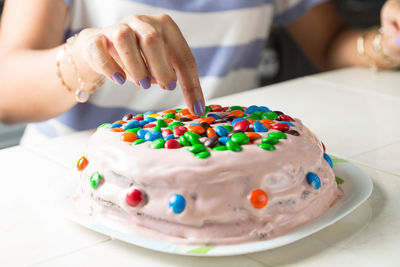 A woman decorating a home made cake
