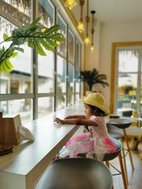 Portrait of young woman looking at outdoor cafe